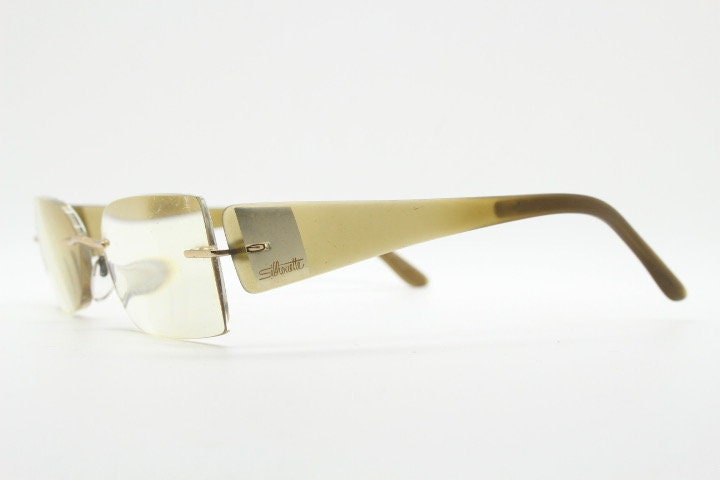 Silhouette rectangular frameless eye glasses model 7599 made in Austria. Minimal optical frame with transparent brown arms. Prescription RX