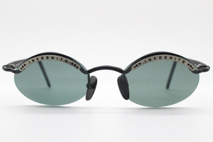 Inkognito 90s vintage small oval sunglasses. Matt finish half frame with spell out logo brow and polarising lenses. NOS