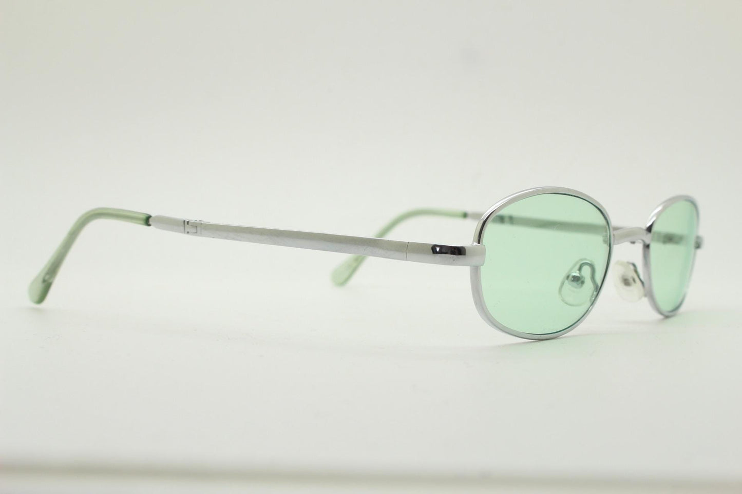 90s micro foldable oval sunglasses. Light green lenses in a small silver folding compact frame. Folder. Rave 2000s. Y2K. NOS