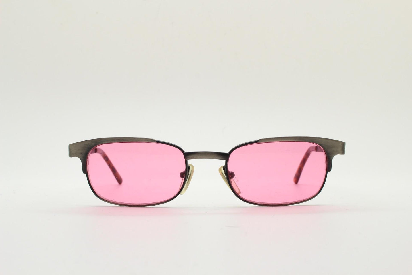 90s vintage rectangular sunglasses with bright pink lenses. Solid metal low profile frame in a brushed bronze finish. Y2K. NOS