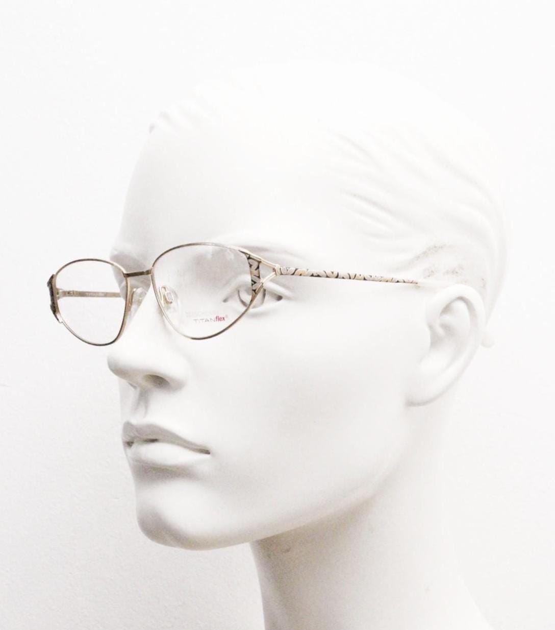 Eschenbach 90s vintage cropped cat eye glasses. Low profile gold metal optical frame with tasteful metallic arm pattern. Prescription. NOS