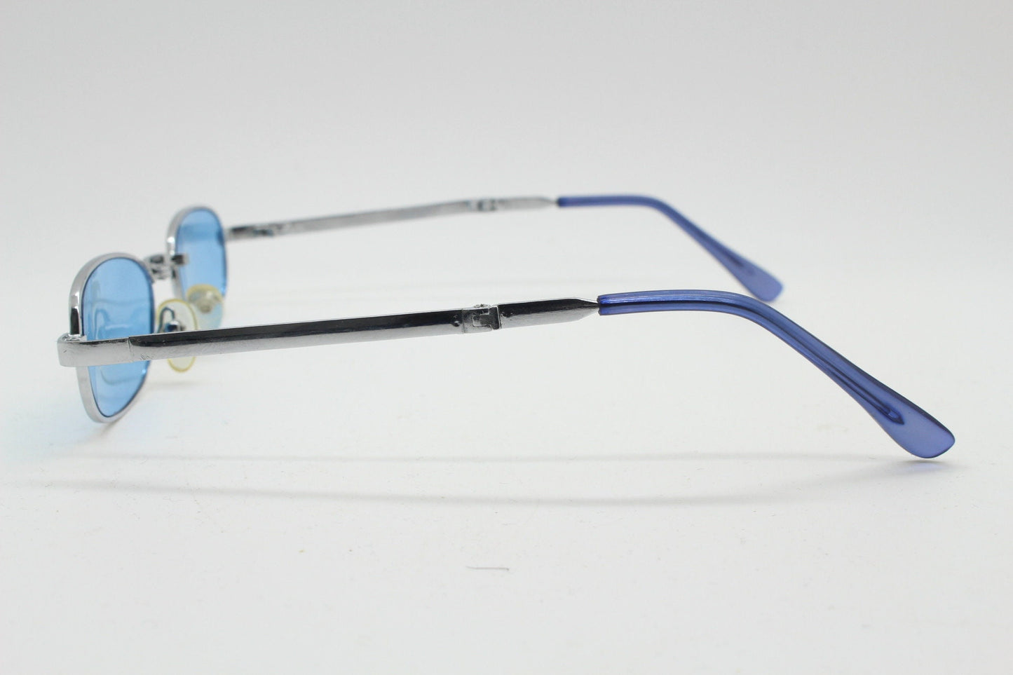 90s micro foldable oval sunglasses. Sky blue lenses in a small silver folding compact frame. Folder. Rave 2000s. Y2K. NOS