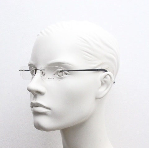 Police 90s vintage rectangular frameless eye glasses made in Italy. Minimal low profile optical frame with black satin metal trim. RX