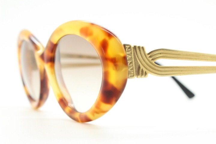 Lanvin 90s vintage chunky oval sunglasses made in France. Mottled honey brown acetate 60s design with detailed arms and light tone lenses