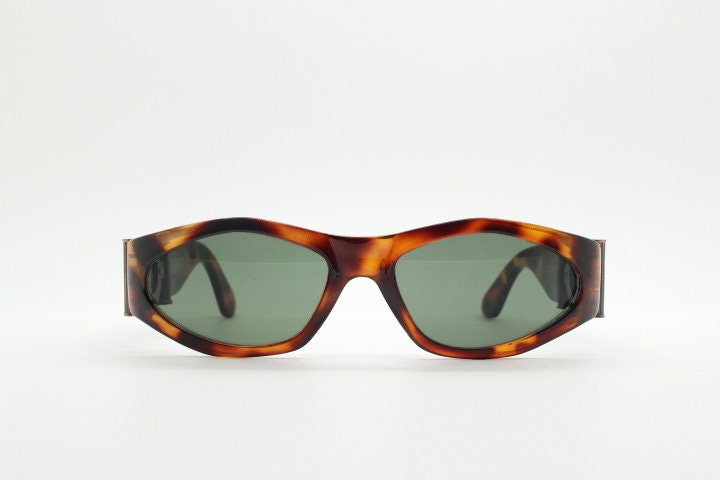 90s vintage oval sunglasses. Low profile transparent tortoise frame with massive bronze metal arm crests BNWT. Unused NOS