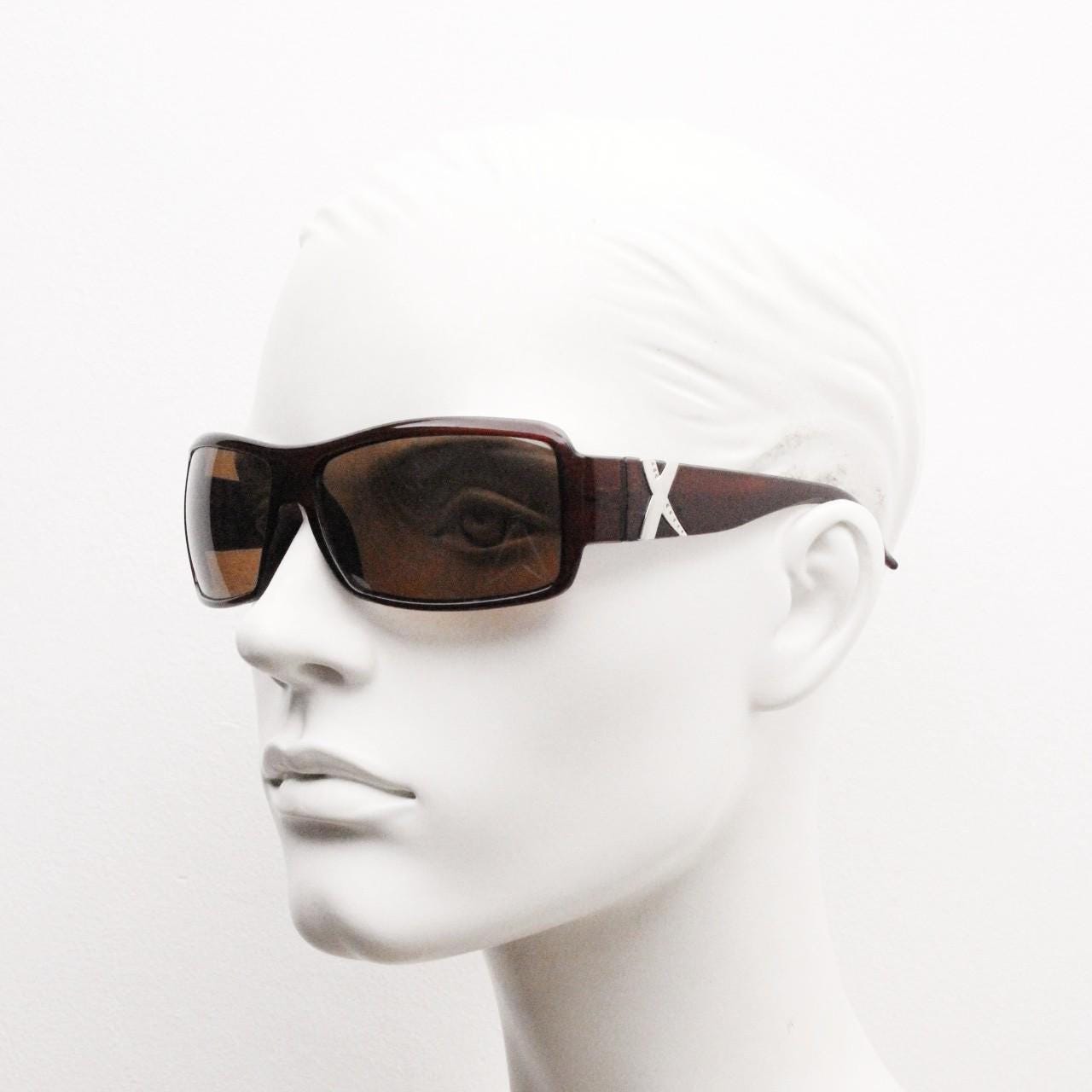 Y2K vintage visor sunglasses. Transparent brown wrap around shield with curved lenses and big X crest. 2000s biker bug eye. NOS