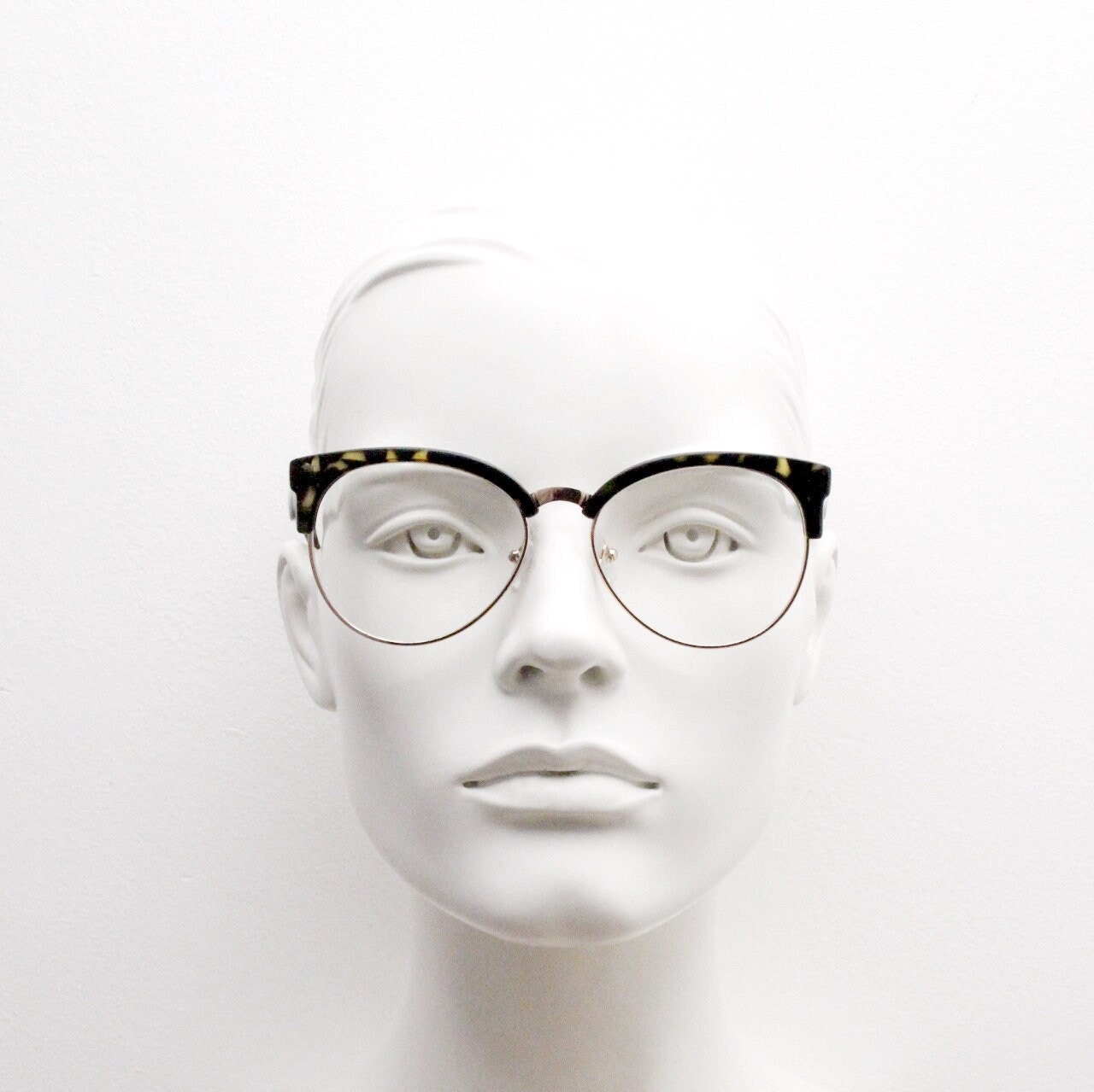 90s vintage modified cat eye glasses. Tortoise browline half frame eyeglasses with gold underwire. 50s, 60s design cateye. NOS