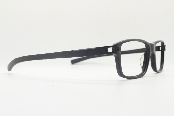 Tag Heuer rectangular eye glasses. Patented design made in France. Solid acetate optical frame with flexible rubber arms. Prescription RX
