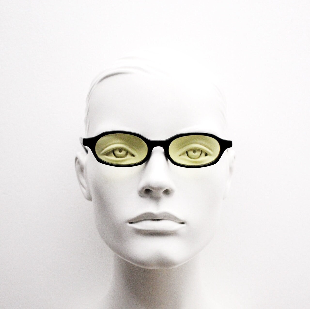 Vintage 90s oval sunglasses. Black low profile matt finish front with yellow lenses and silver chrome arms. Micro