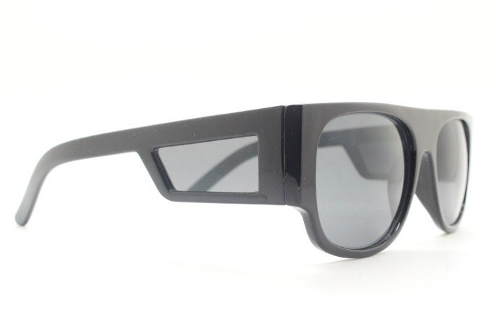 Y2K vintage rectangular side panel sunglasses. Black gloss frame with grey lenses and side window spoilers / blinkers. 2000s NOS goggle