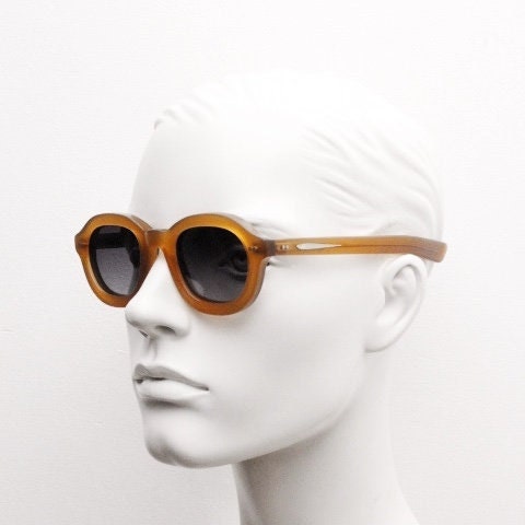 Kopajos thick framed round sunglasses. Hand made transparent amber acetate chunky frame with contrasting graduating lenses