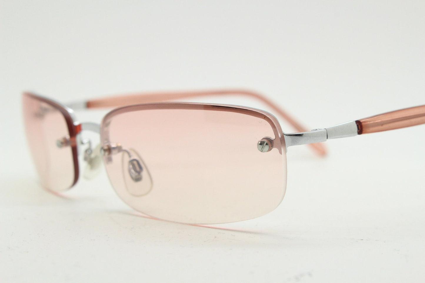 Y2K vintage wrap around rectangular sunglasses. Half frame in sharp chrome with extra light tone pink lenses. Rave 2000's. 00's NOS