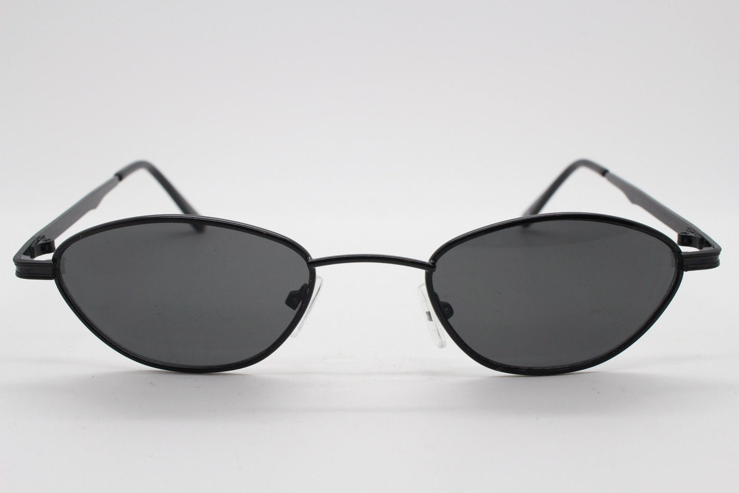 90s vintage low profile sunglasses. Minimal small black angular oval metal frame with matching lenses, Unused. BNWT
