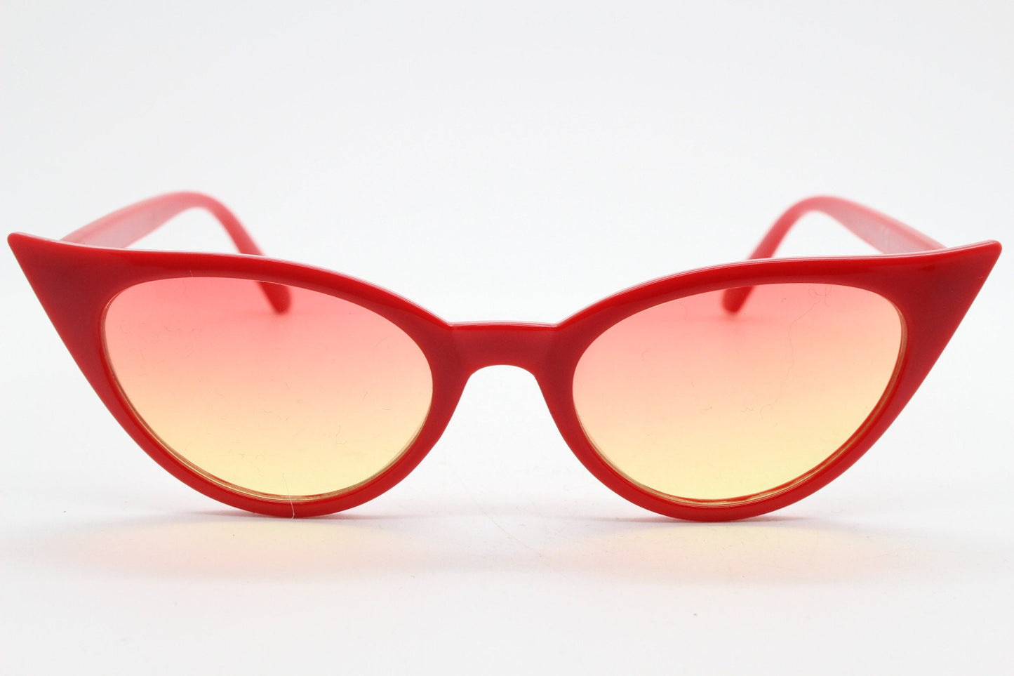 Y2K vintage pointed cat eye sunglasses. Red slender frame with graduating lenses. Womens 50s style rockabilly, pin up shades