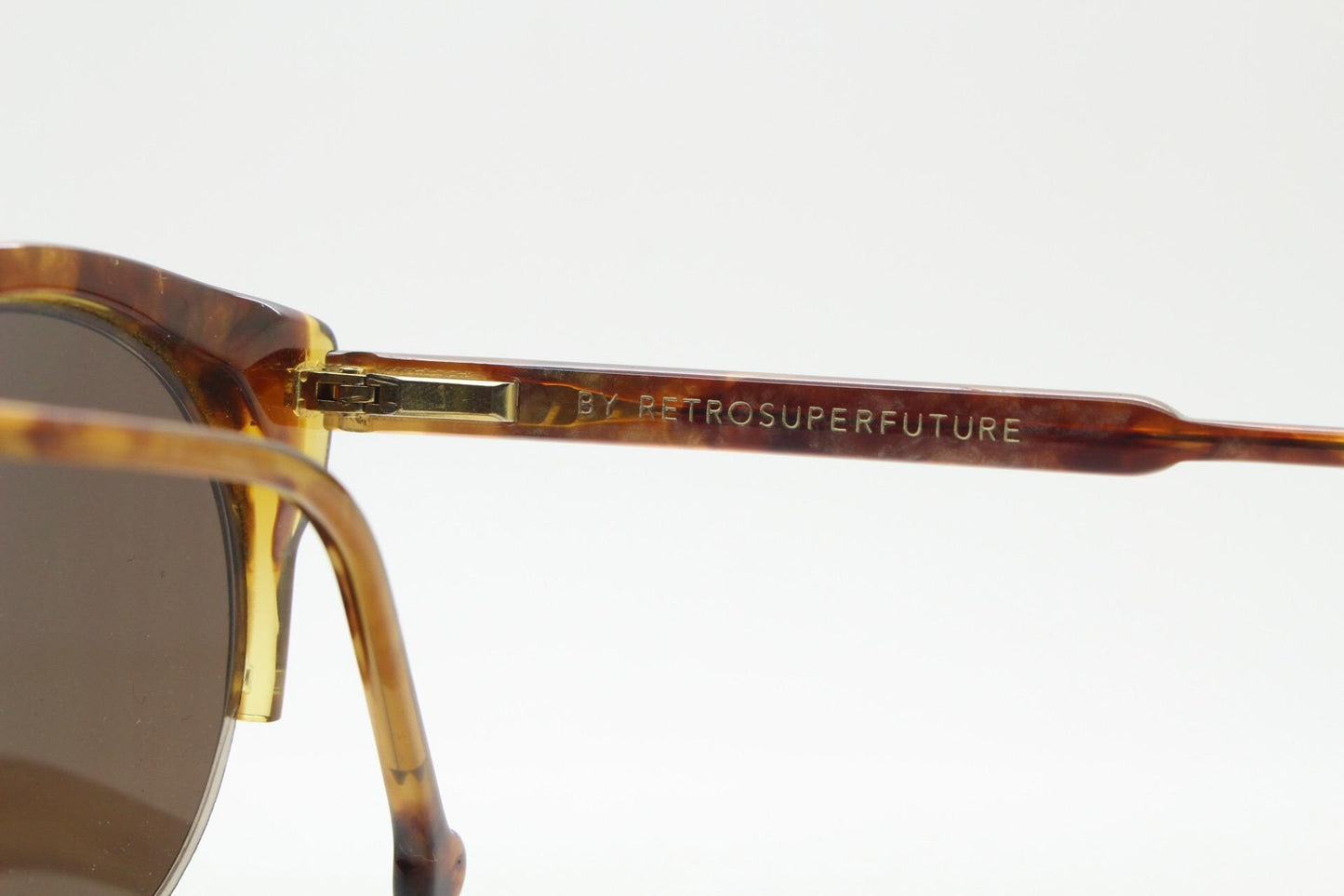 Retrosuperfuture vintage angular cat eye sunglasses made in Italy. Marbled brown gloss acetate flat top half frame with round lenses