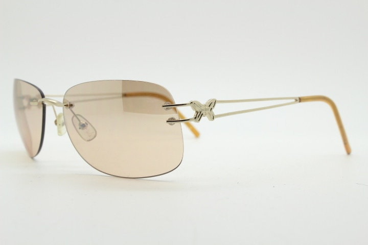 Y2K vintage rimless rectangular sunglasses. Frameless 2000's brown lens with slight mirror glaze gold trim and butterfly hinges. 00's NOS