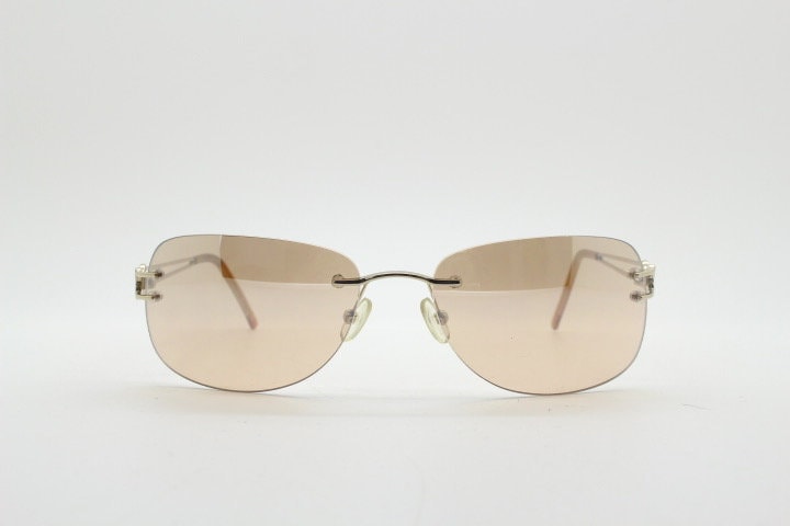 Y2K vintage rimless rectangular sunglasses. Frameless 2000's brown lens with slight mirror glaze gold trim and butterfly hinges. 00's NOS