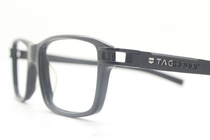 Tag Heuer rectangular eye glasses. Patented design made in France. Solid acetate optical frame with flexible rubber arms. Prescription RX