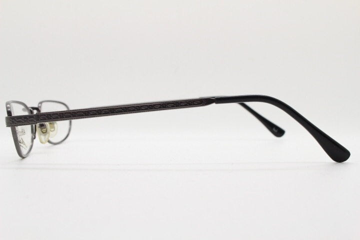 Alberta Ferretti 90s vintage oval eye glasses made in Italy. Small grey metal optical frame with ornate arm pattern. Prescription RX. NOS