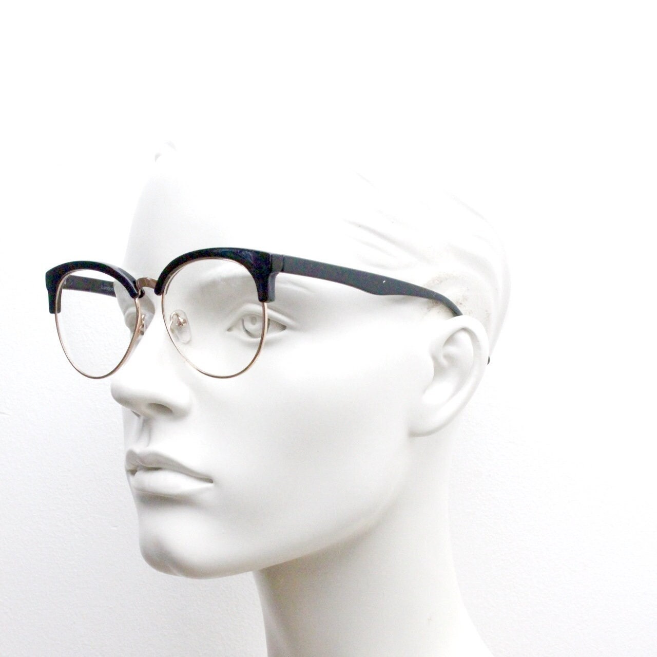 90s vintage modified cat eye glasses. Black gloss browline half frame eyeglasses with gold underwire. 50s, 60s design cateye. NOS
