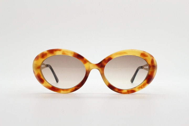 Lanvin 90s vintage chunky oval sunglasses made in France. Mottled honey brown acetate 60s design with detailed arms and light tone lenses