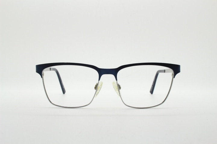Karl Lagerfeld squared wayfarer shape eye glasses. Navy check pattern arms with satin finish brow optical frames. Prescription eyeglasses.
