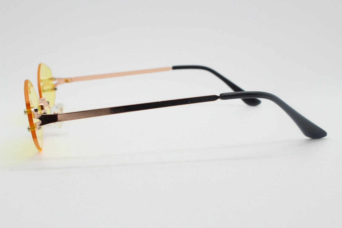 Y2K vintage frameless hexagon sunglasses. Bright yellow lenses with rose gold bridge and arms. 2000s, 00's. 90s