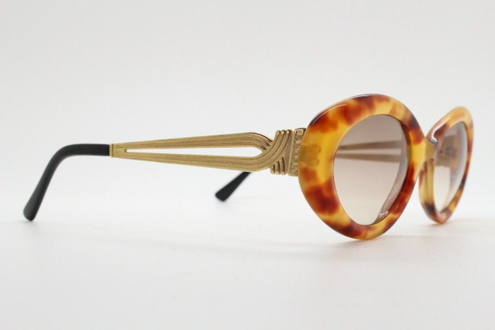 Lanvin 90s vintage chunky oval sunglasses made in France. Mottled honey brown acetate 60s design with detailed arms and light tone lenses