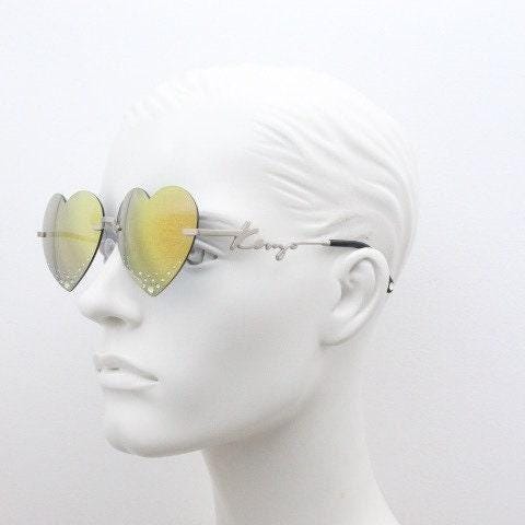Kenzo mirror heart shaped frameless sunglasses model KZ40005U. Instant classic design with diamantes and big spell out arm logo. NOS