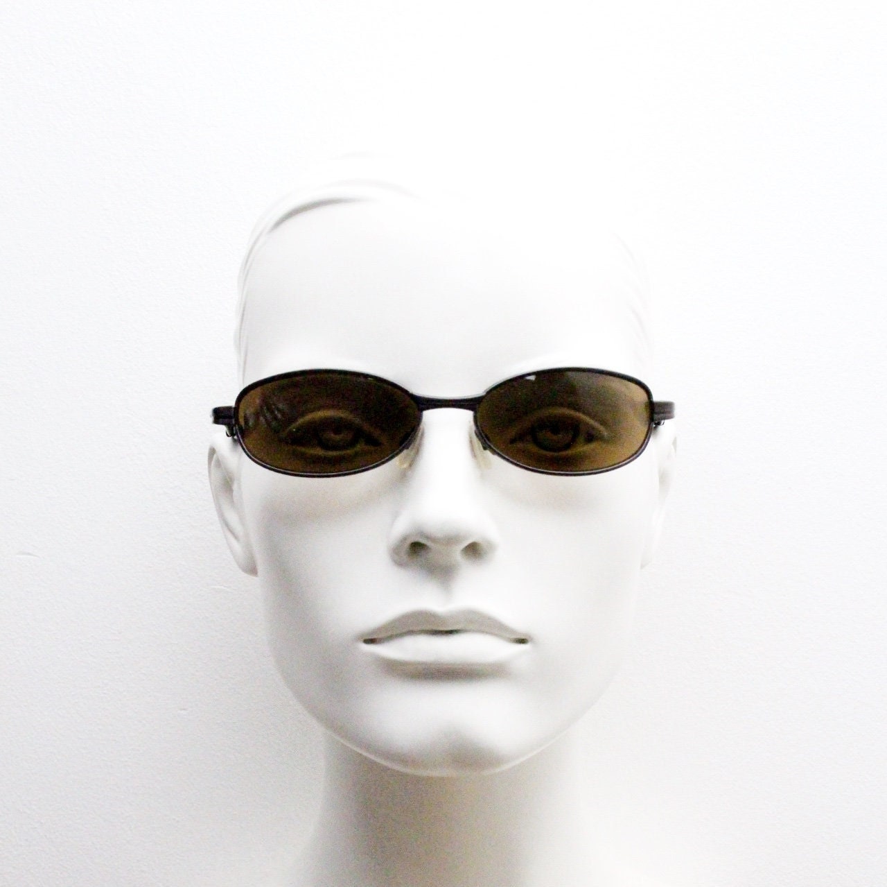 90s vintage oval small bug eye sunglasses. Curved brown satin finish solid metal frame with spear point rubber ends. Steampunk. Quality NOS