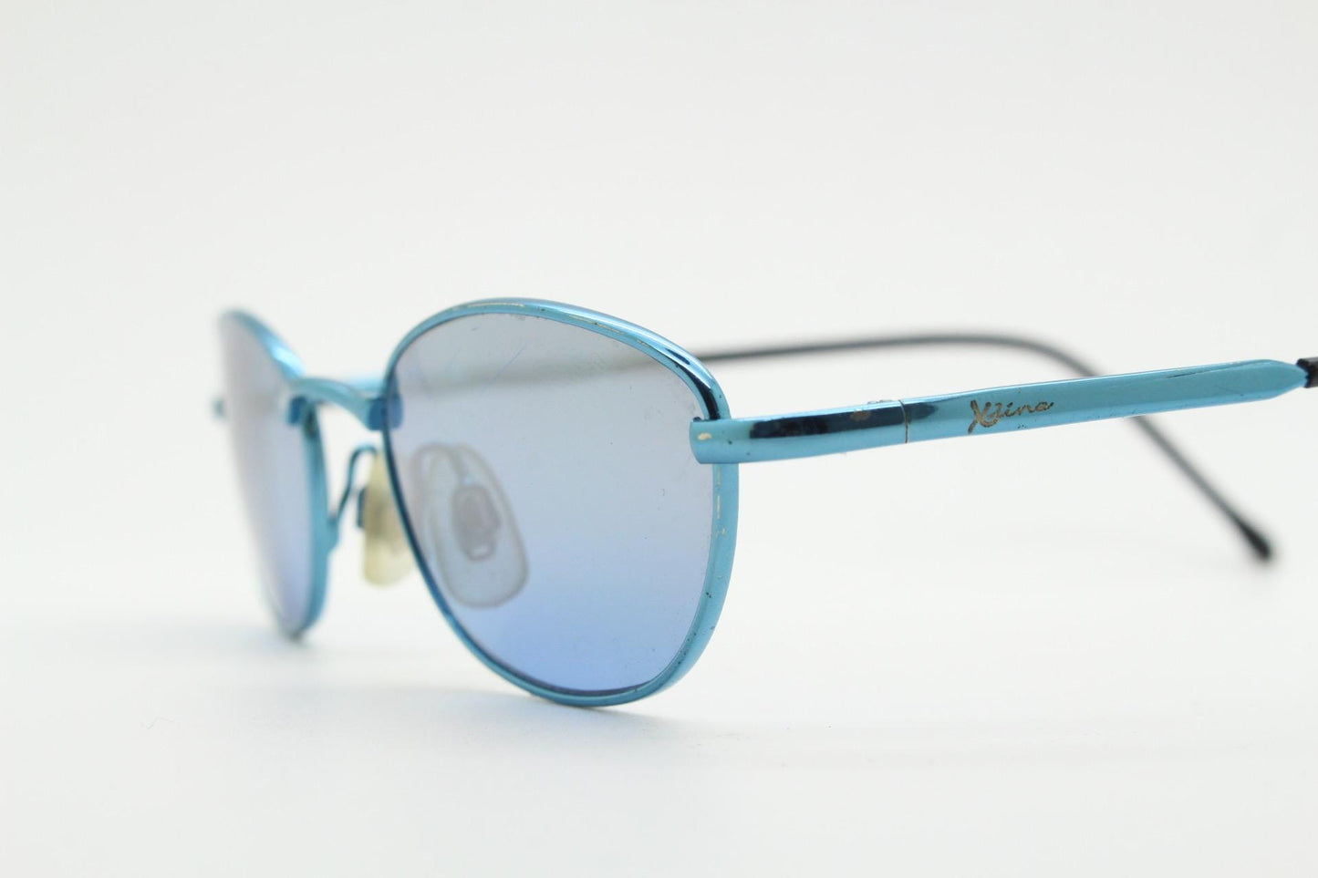 90s vintage small oval sunglasses by X-line. Unusual blue chrome metal frame with well matched mirror lenses. Quality NOS