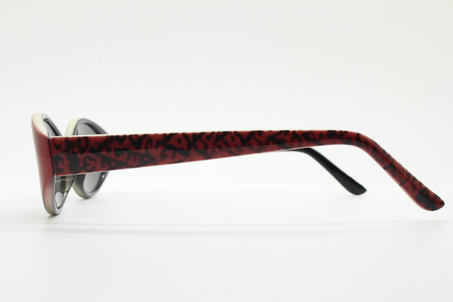 Vintage 90s oval sunglasses with very unique abstract arm pattern in black and red on layered acetate. Authentic original design. NOS