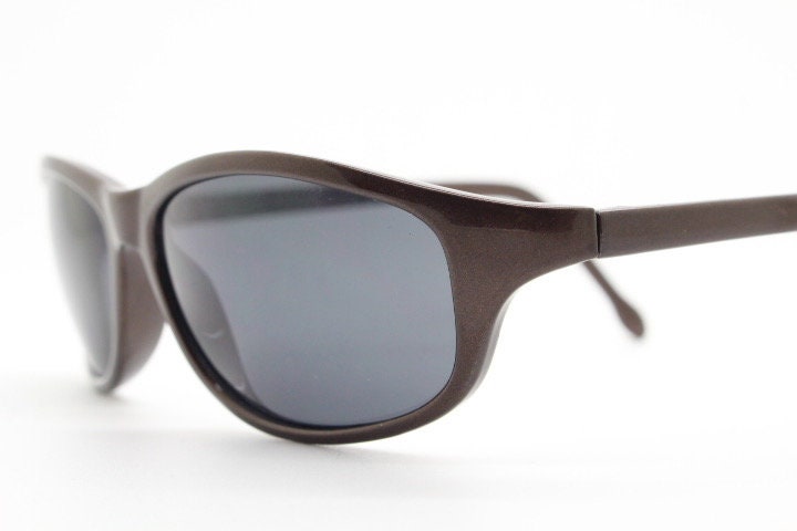 Y2K vintage wrap around shield sunglasses. Brown aerodynamic high gloss frame with black curved lenses. 2000's sport. New Old Stock 90s