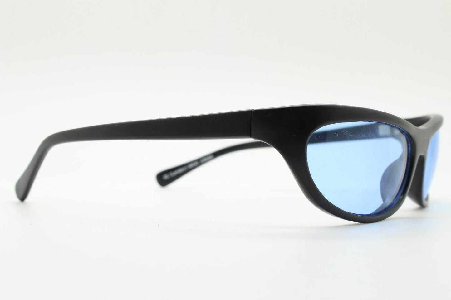 90s vintage curved wraparound sunglasses. Aerodynamic low profile black satin finish frame with light tone blue lenses. Sports shield. NOS
