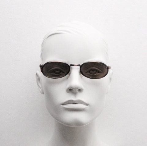 90s vintage oval sunglasses. Handsome metallic brushed copper finish with arm cut outs. Unused NOS