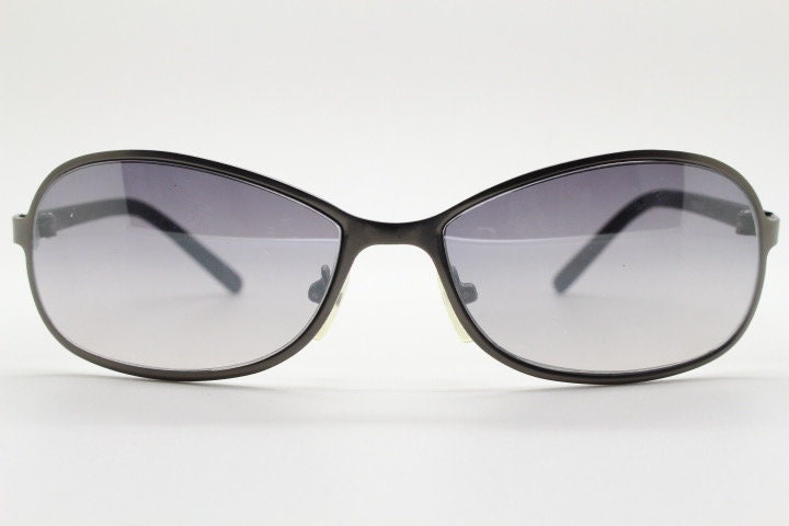 Y2K vintage mini bug eye sunglasses. Curved gunmetal grey flat metal frame with black matt arms and graduating lenses. Unused 2000s NOS