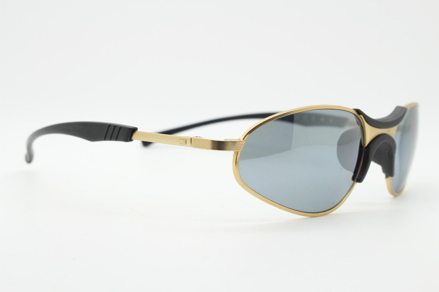 90s vintage oval small bug eye sunglasses. Curved gold satin finish metal frame with black matt trim and adjustable arm length. Unused NOS