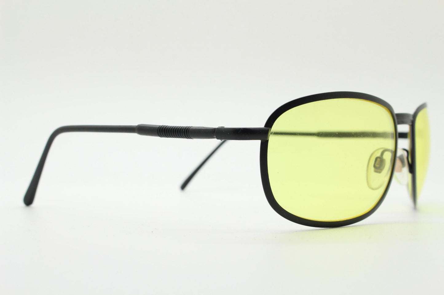 90s vintage oval bug eye sunglasses. Matt black metal frame with blazing yellow lenses and ingenious temple springs. 2000s. NOS