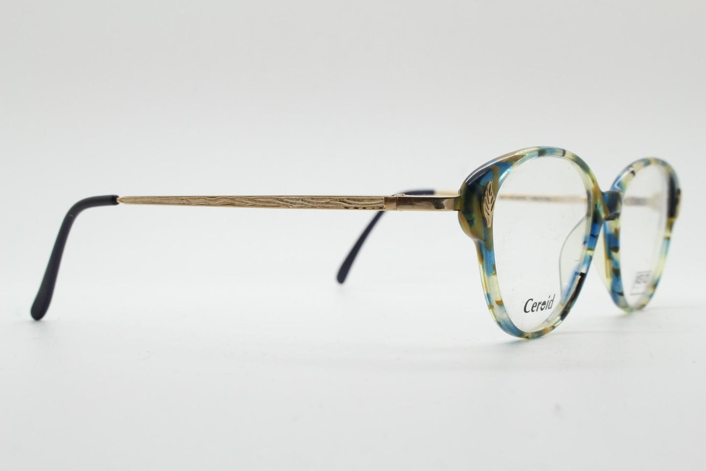 Kenzo 90s vintage cat eye glasses hand made in France. Transparent patterned optical frame with ornate arm details. Womens Prescription. NOS