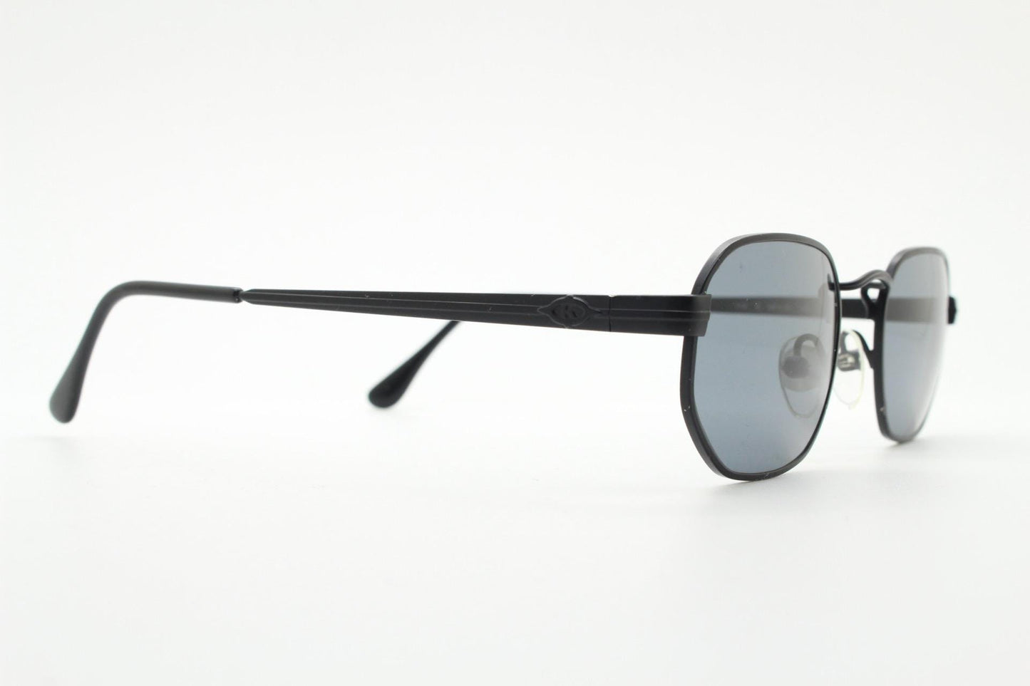 Prestige 90s vintage small oval sunglasses model 119 made in Italy. Black matt metal frame with with subtle angular facets, NOS octagon