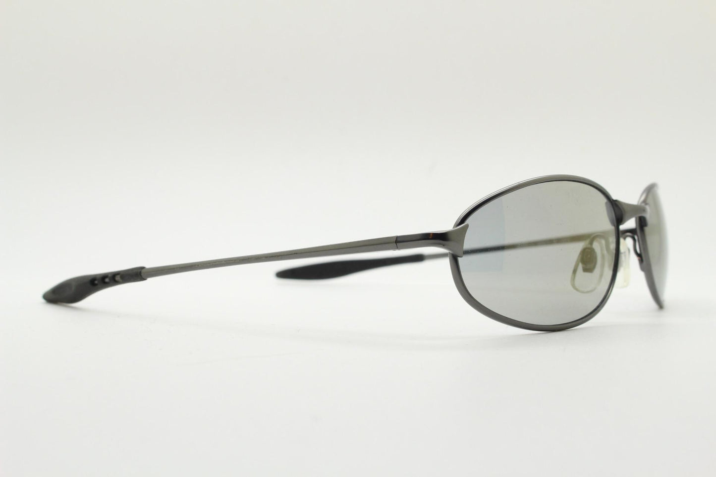 90s vintage oval small bug eye sunglasses. Satin finish frame in gunmetal with straight spear arms. Y2K. 2000s. Unworn NOS