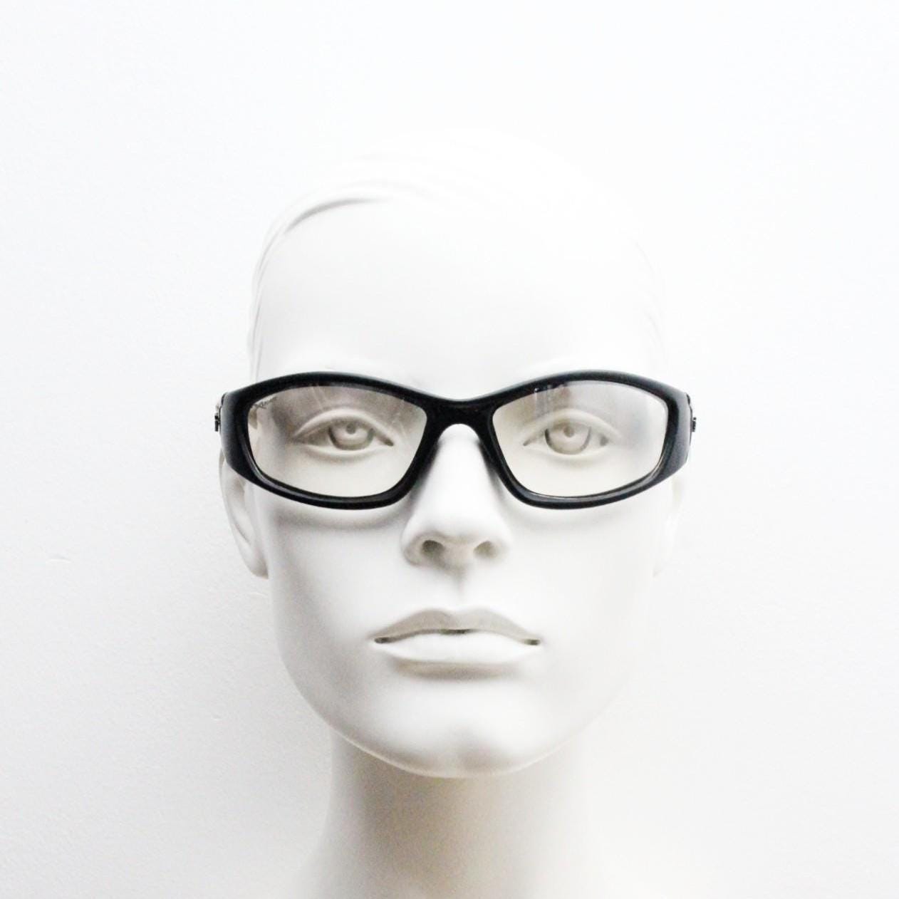 90s vintage sports sunglasses. Black matt aerodynamic wraparound with straight white rubber arms and light tone lenses. Y2K rave shield