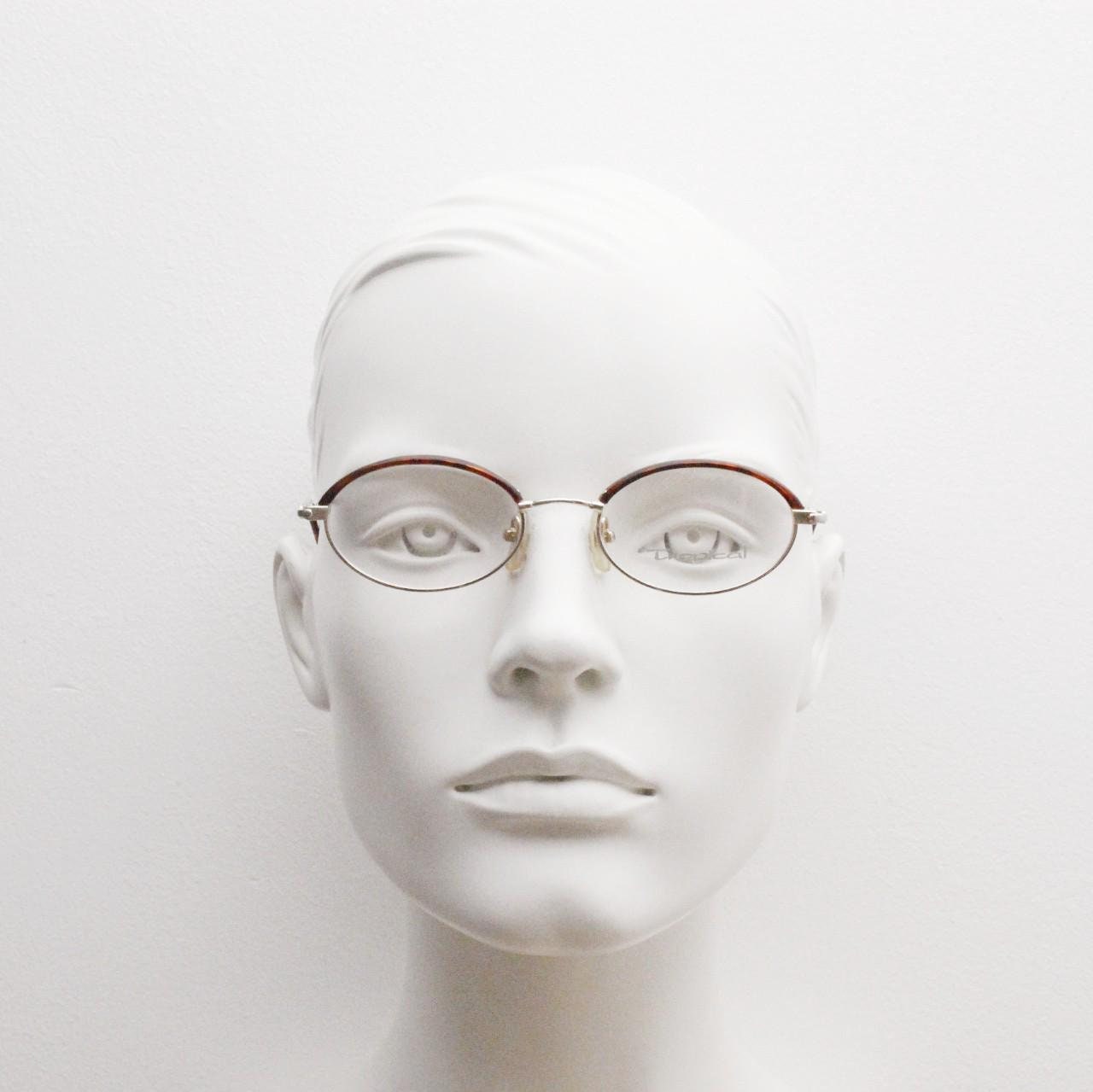 90s vintage small oval eye glasses by Tropical. Minimal gold optical frames with tortoise arms and brows. Prescription RX spectacles. NOS