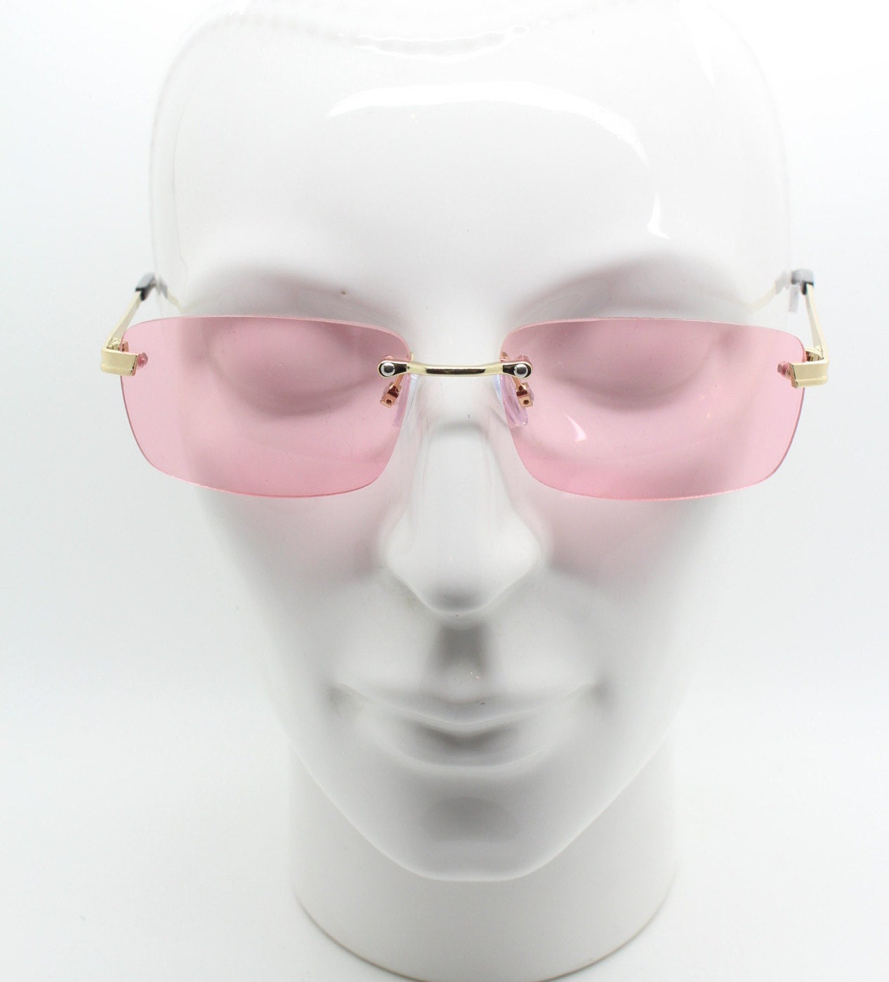 Y2K vintage frameless pink sunglasses. Rectangular lenses with gold bridge and arms. 2000s club kids. 00's. 90s Rave