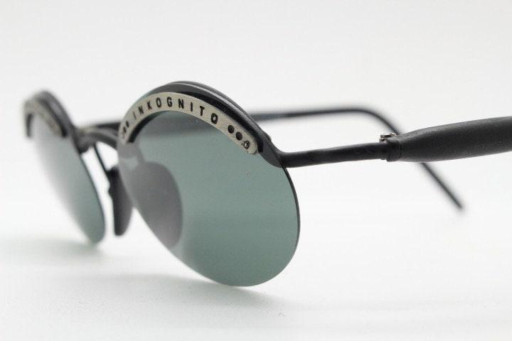 Inkognito 90s vintage small oval sunglasses. Matt finish half frame with spell out logo brow and polarising lenses. NOS