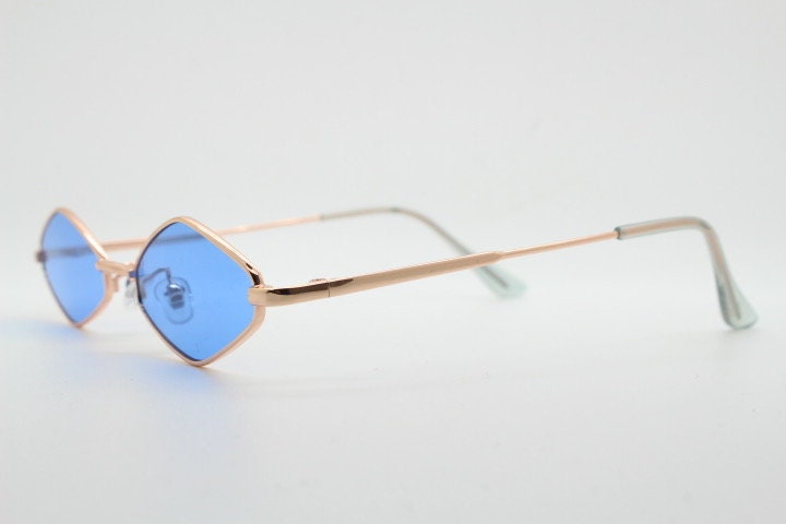90s vintage small diamond sunglasses. Minimal gold psychedelic mod style frame with sky blue lenses. Unused New Old Stock