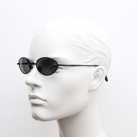 90s vintage oval sunglasses. Minimal plain matt black metal frame with unusual indented arm patterns. Unused NOS