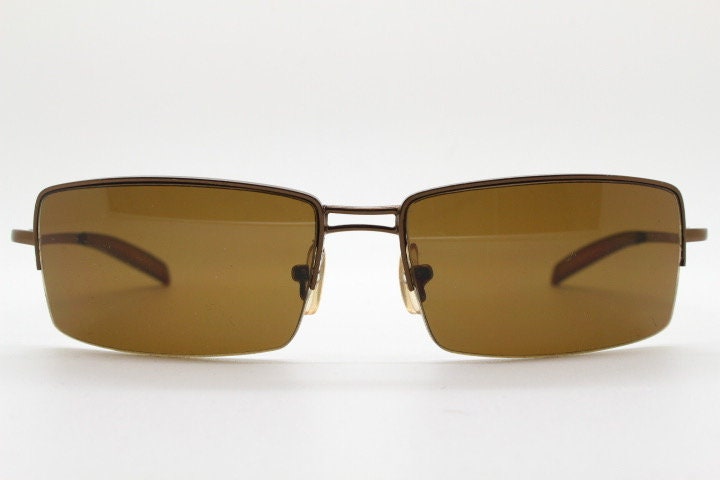 Y2K vintage curved rectangular sunglasses. Minimal half frame in brown chrome with mid tone lenses and straight arms. 2000's. 00's NOS
