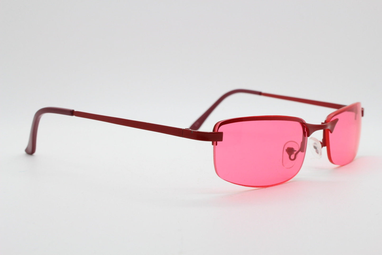 Y2K vintage half frame sunglasses with rectangular pink lenses and matching frame colours. 2000s NOS. 00's. 90s Rave