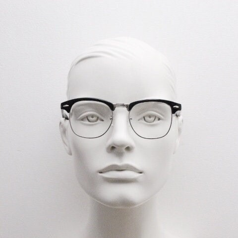 90s vintage black half frame eye glasses. Black gloss browline with silver wire rim frame and clear lenses. Classic 50s, 60s design. NOS